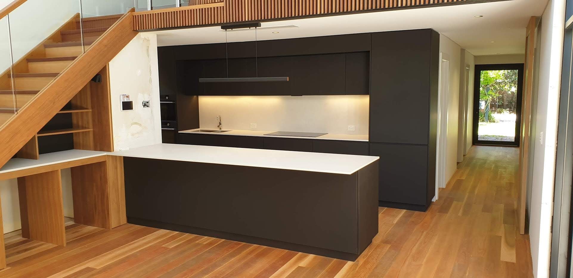 Modern kitchen with timber cabinetry and stone benchtop